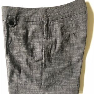 Dressy gray shorts with black buttons.